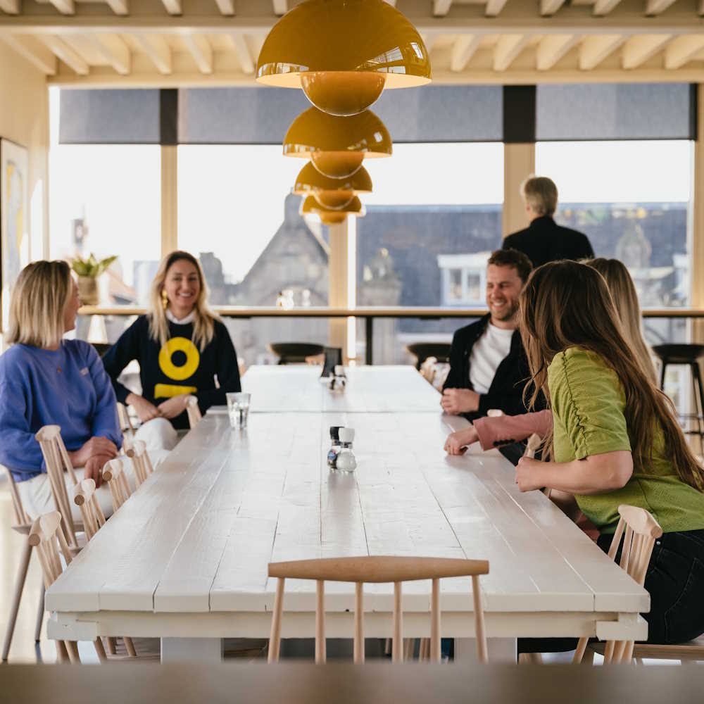 a group of people meeting at a large table